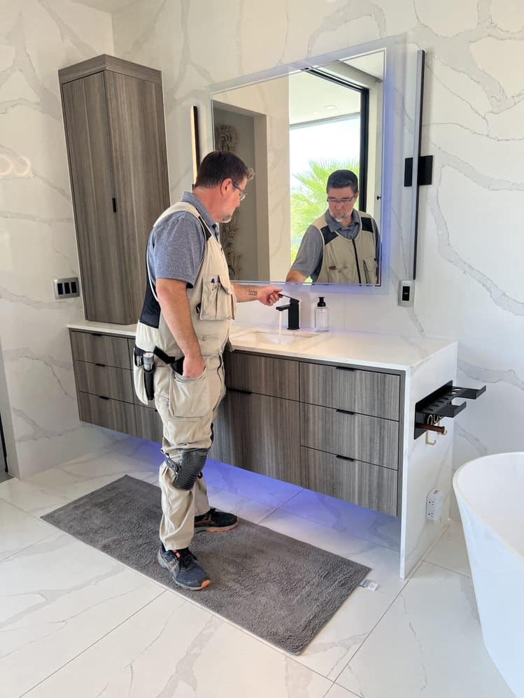 Luxury home inspection in Phoenix — professional inspector examining bathroom faucets for cracks, water pressure, and structural integrity.